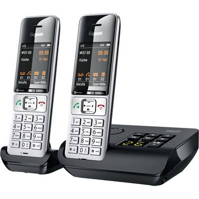 Two cordless telephones with base station. Displays show time, date, and menu options. Suitable for home use.