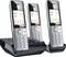Three black cordless telephones with base station. The screens display time, date, and call information.