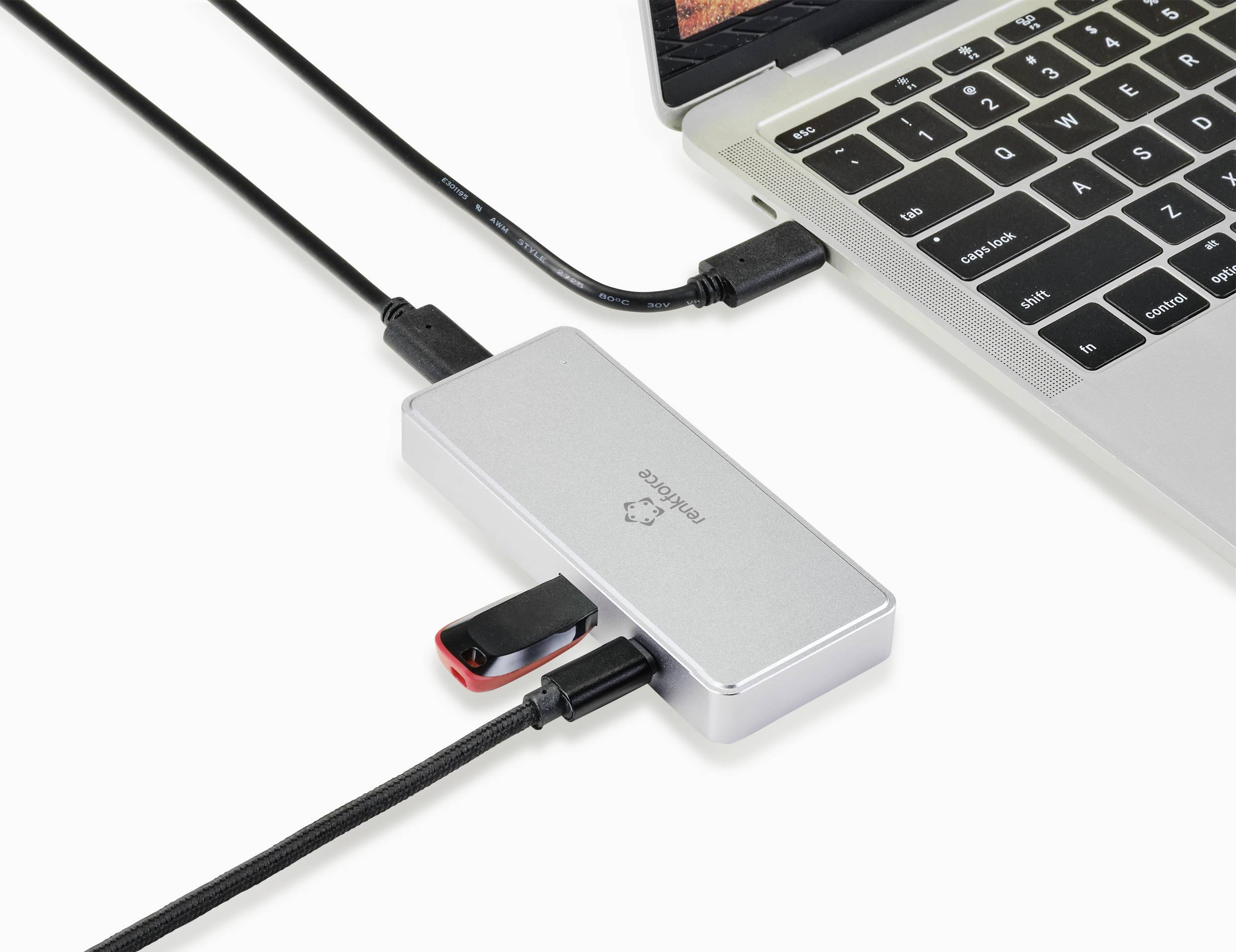 A laptop is connected to multiple devices such as a USB drive and cables via a USB hub, enabling data transfer.