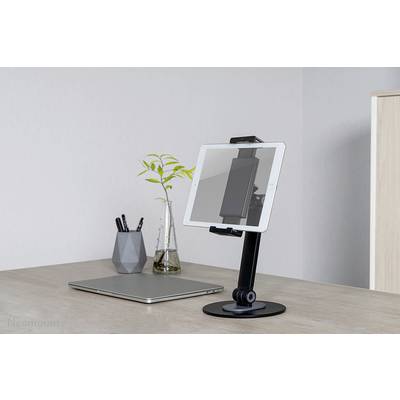 'Desk with laptop, tablet stand and vase with plant, modern and tidy workspace.'