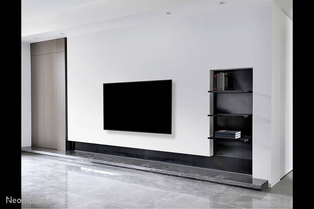 Living room with modern design. A large flatscreen television is mounted on a white wall with a black shelving unit beside it.