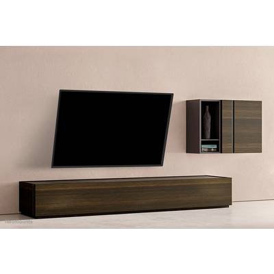A modern living room setup with a wall-mounted flat-screen television at an angle, with a wooden shelving unit beside it adorned with decorative items.