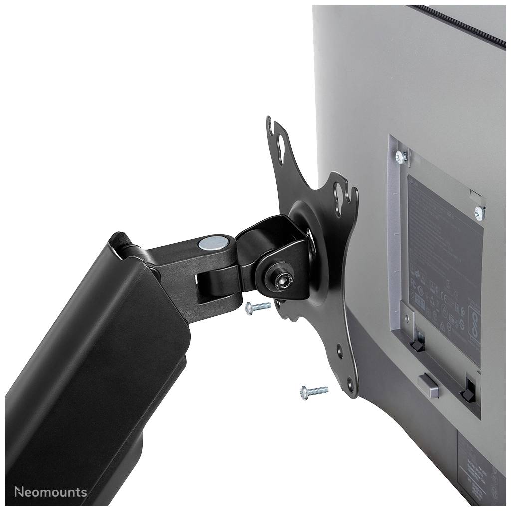 Mounting a monitor bracket onto a screen using screws.