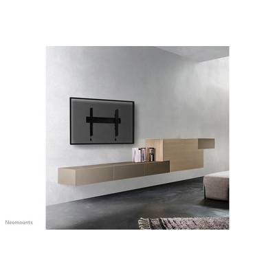 Television wall mount installed in modern living room. Image shows wall mount against minimalist room design with furniture.