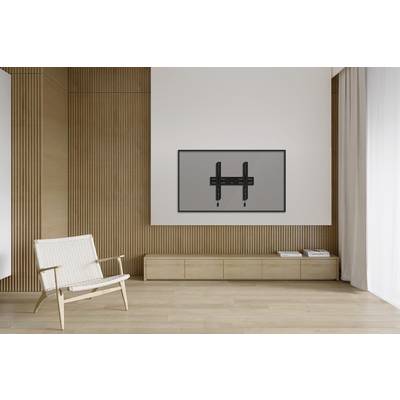 Modern living room with light wooden decor, a simple chair and minimalist TV wall mount on a white wall next to a large window.