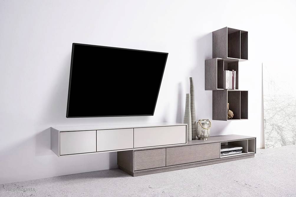 Modern living room wall with an angled flatscreen television, floating sideboard and open shelves. Minimalist design.