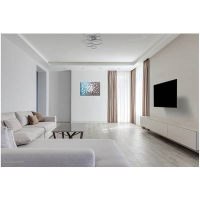 Bright living room with sofa, coffee table, wall art, large window and wall-mounted television. Subtle, modern decor.