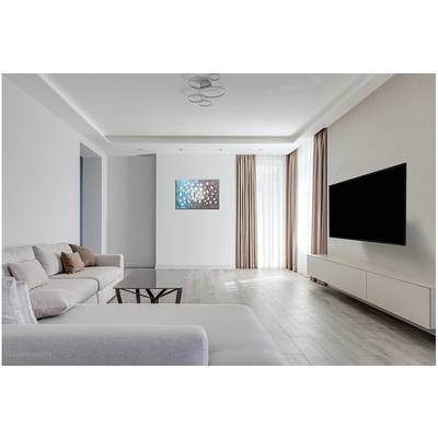 Modern living room with a light-coloured sofa, coffee table and large flat-screen television mounted on the wall. Floor-to-ceiling windows with curtains.