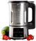 A blender with a digital display and buttons, surrounded by fresh vegetables, including courgettes and tomatoes, on a white background.