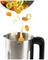 Round carrot slices and leek rings fall into a metal container with a black handle, marked with MAX 1.2 L.