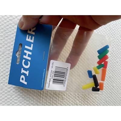 The hand is holding a plastic packaging containing small, colourful, tubular parts. On the blue packaging is written 'Pichler'.