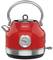 A red kettle with a temperature display on the front, featuring a traditional design and chrome accents.