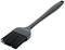 A black kitchen brush with long bristles and an ergonomic handle, suitable for brushing food.
