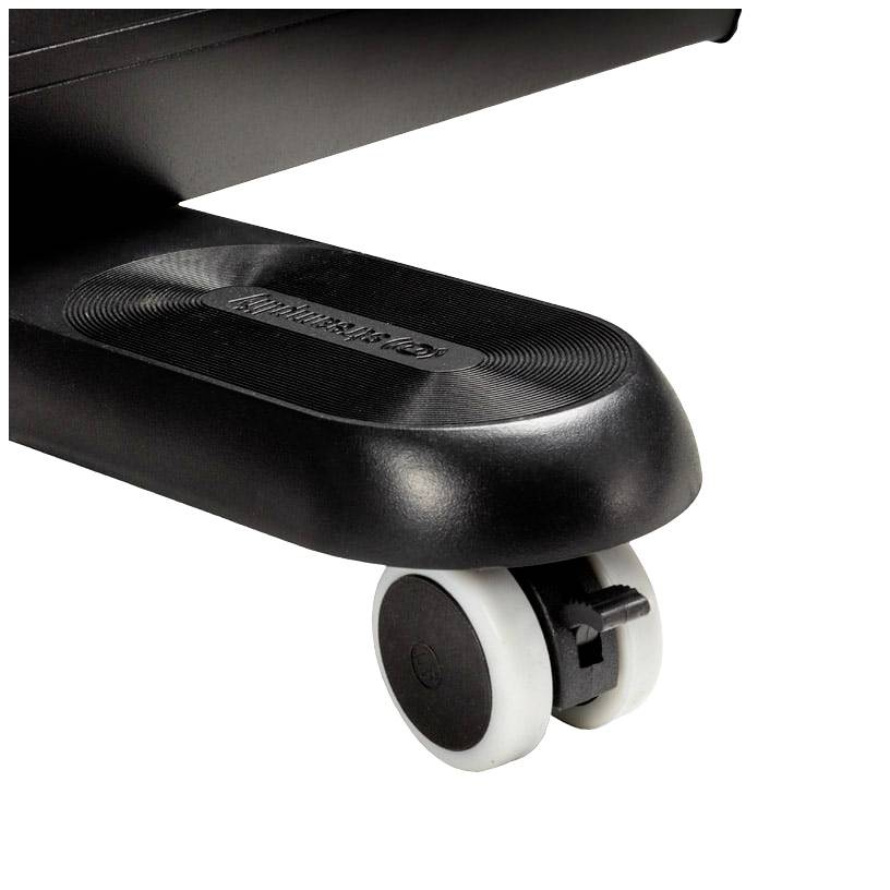 Close-up of a black chair leg with two white castors standing on a carpeted floor.
