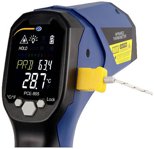 An infrared thermometer displays a temperature of 28.7 °C on a digital display, with a yellow button on the side.