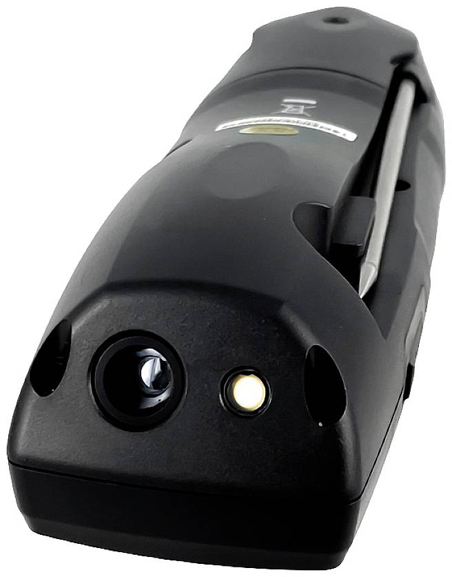 A black electronic device is lying on its side. It has a lens and a metal tool attached to its side.