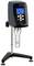 'Viscometer with digital display' shows measuring values for viscosity, temperature and rotational speed. Device stands on a stable stand.