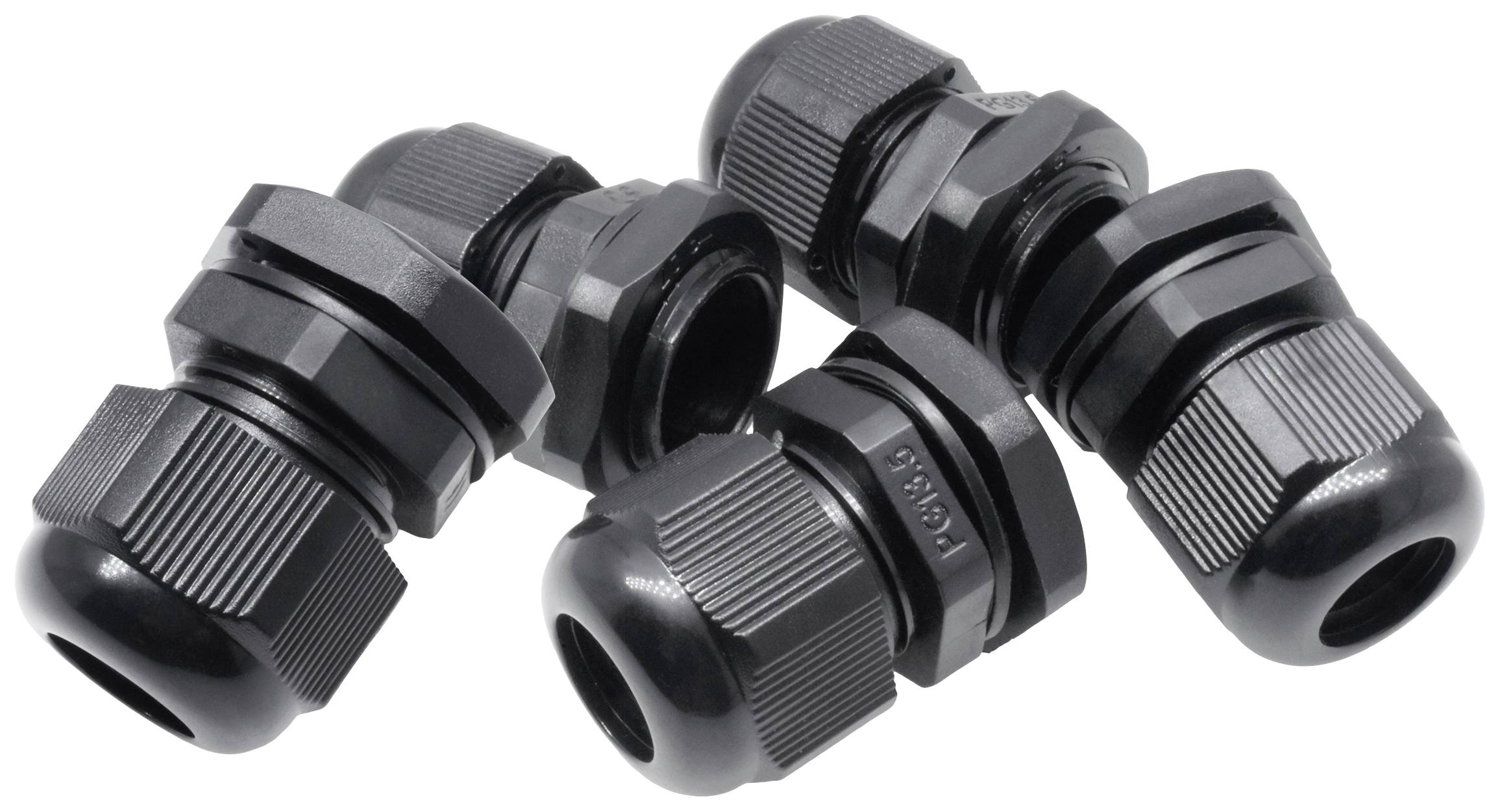 Three black plastic cable glands are lying on a white background. They are suitable for sealing cable entries.