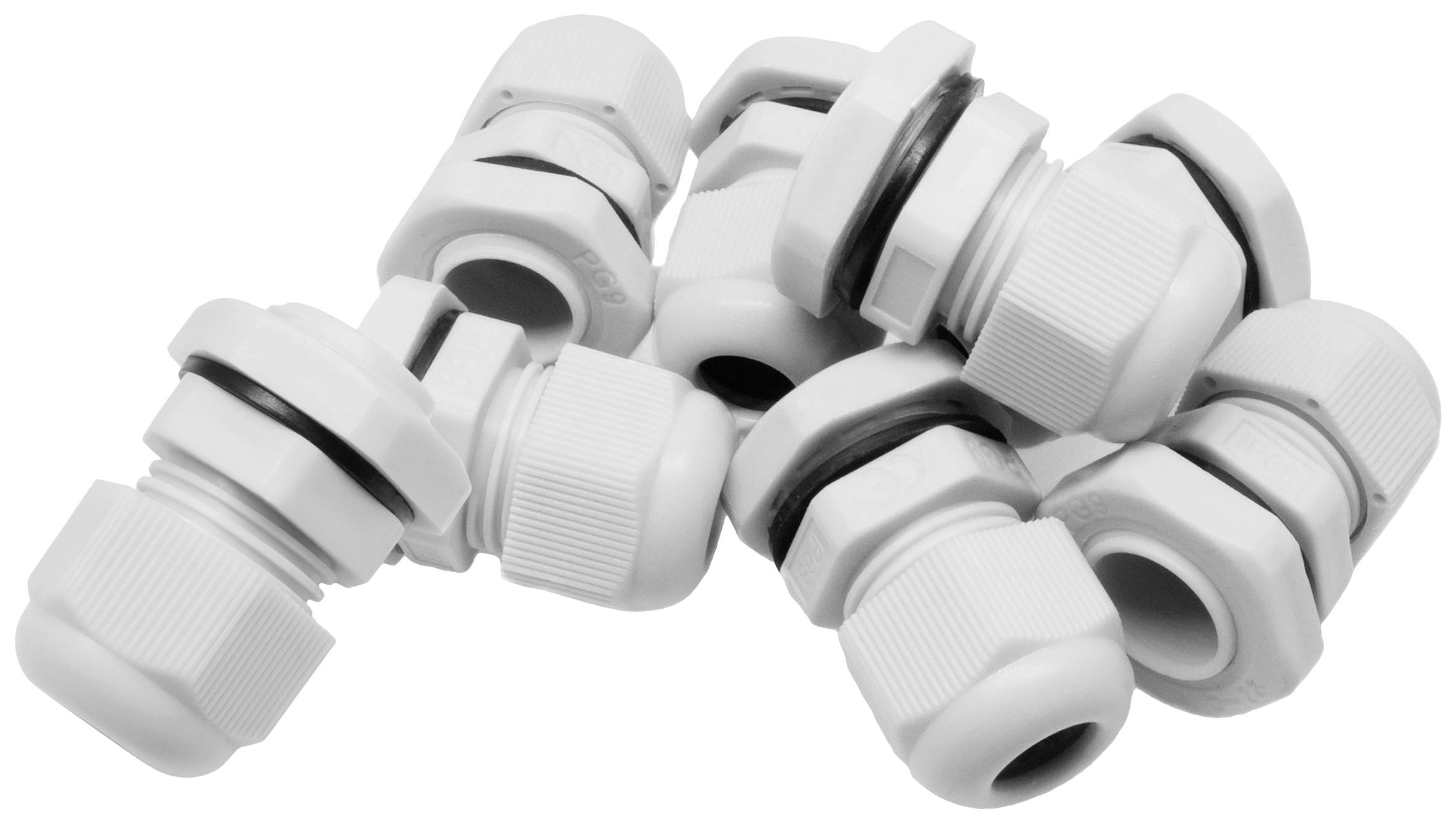 Several white cable glands are lying in a pile, with rubber sealing rings clearly visible.