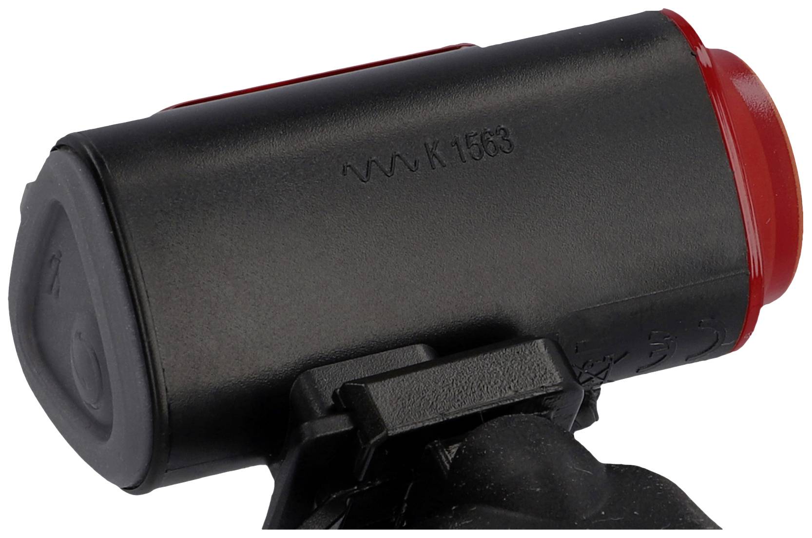 Black and red bicycle rear light with mount, side view.