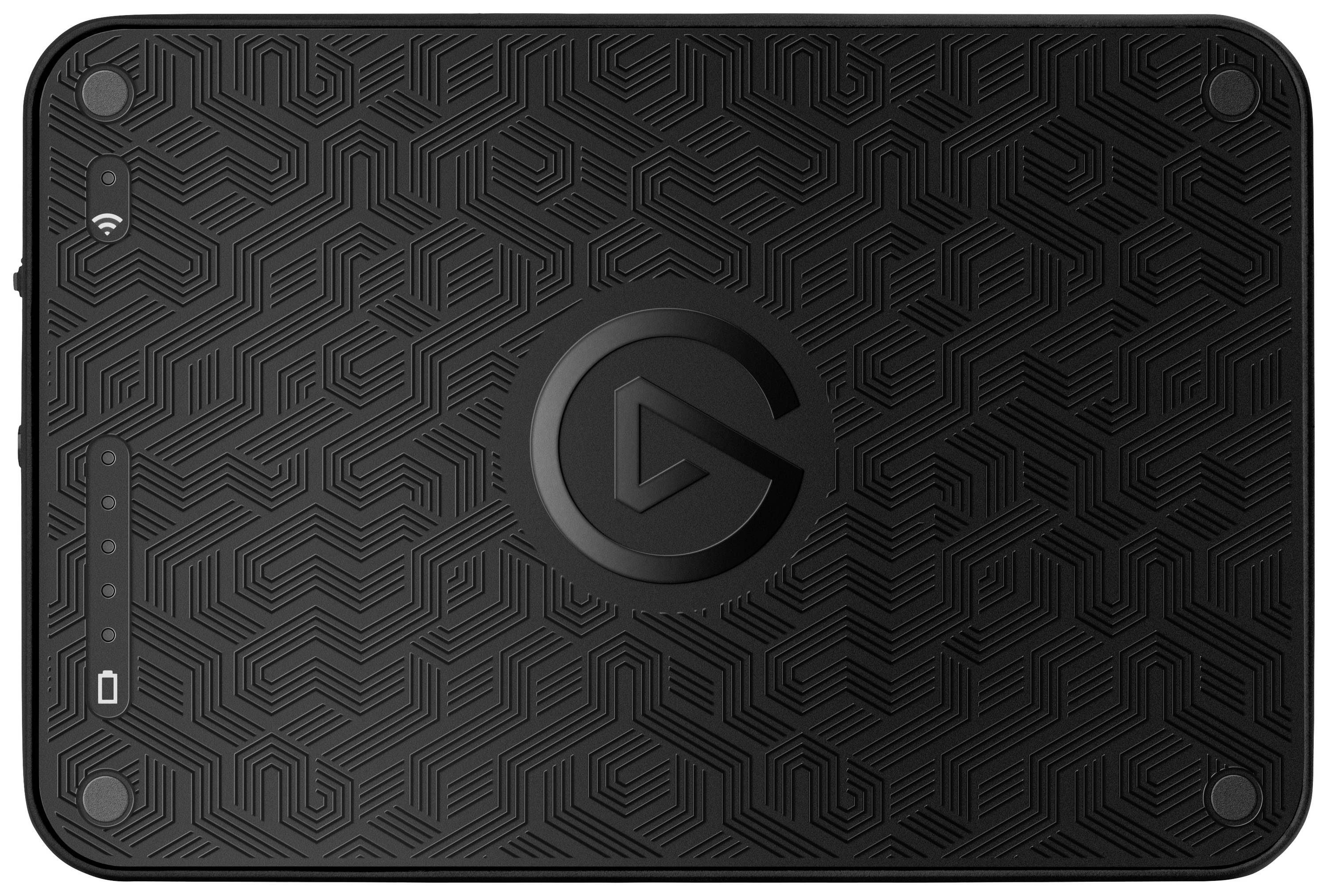 A black device with a textured pattern and a central logo. Several buttons and symbols are located along its side.
