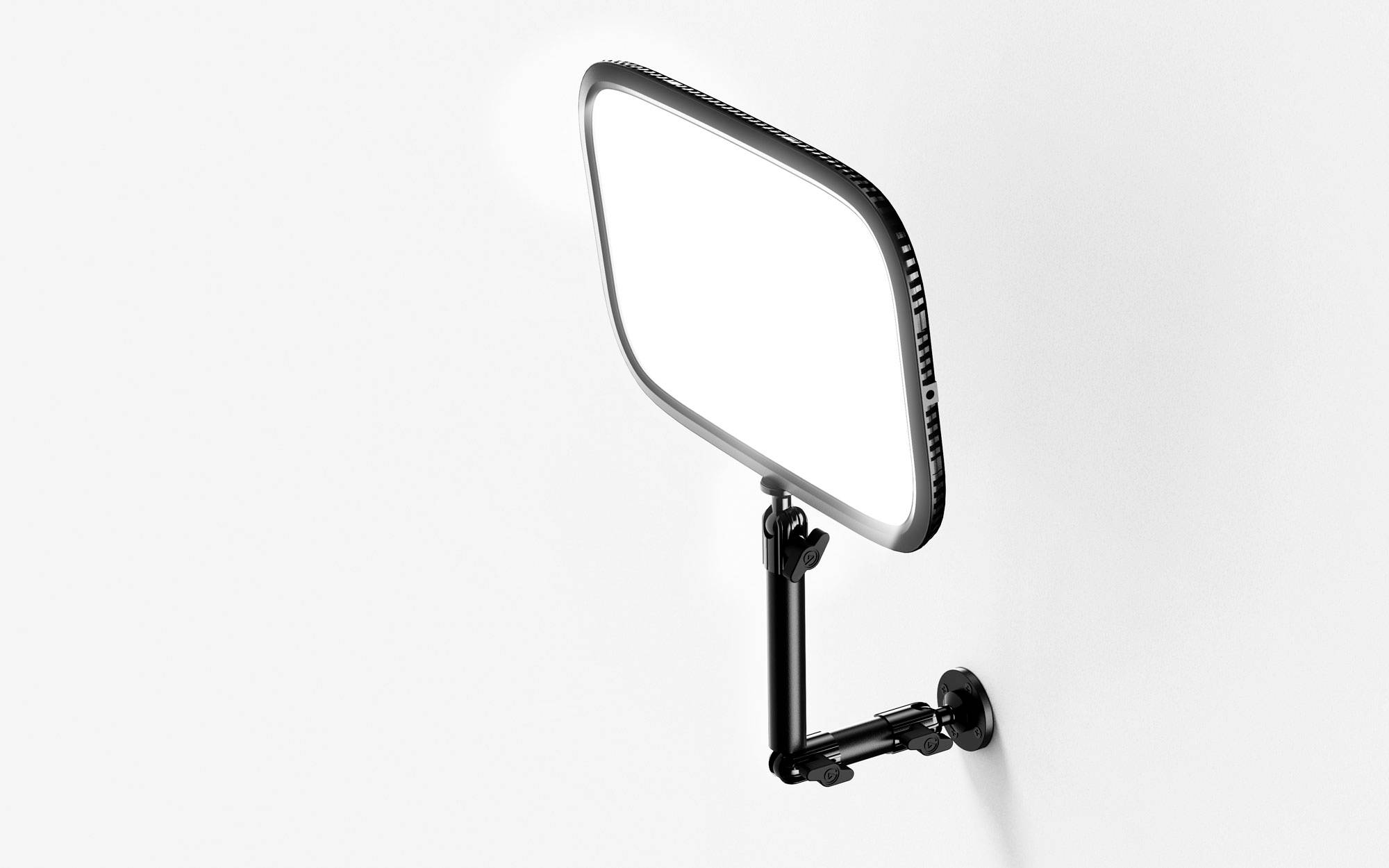 A rectangular mirror with rounded corners is mounted on a pivoting wall bracket.