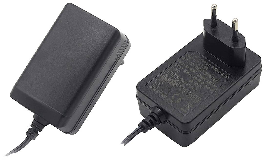 Black power supply with European plug, showing the casing and technical specifications on the back.