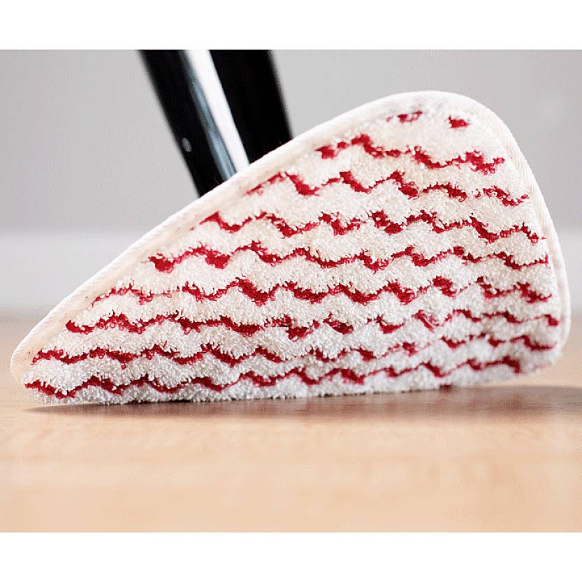 A steam mop with a white and red cleaning pad glides across a wooden floor.