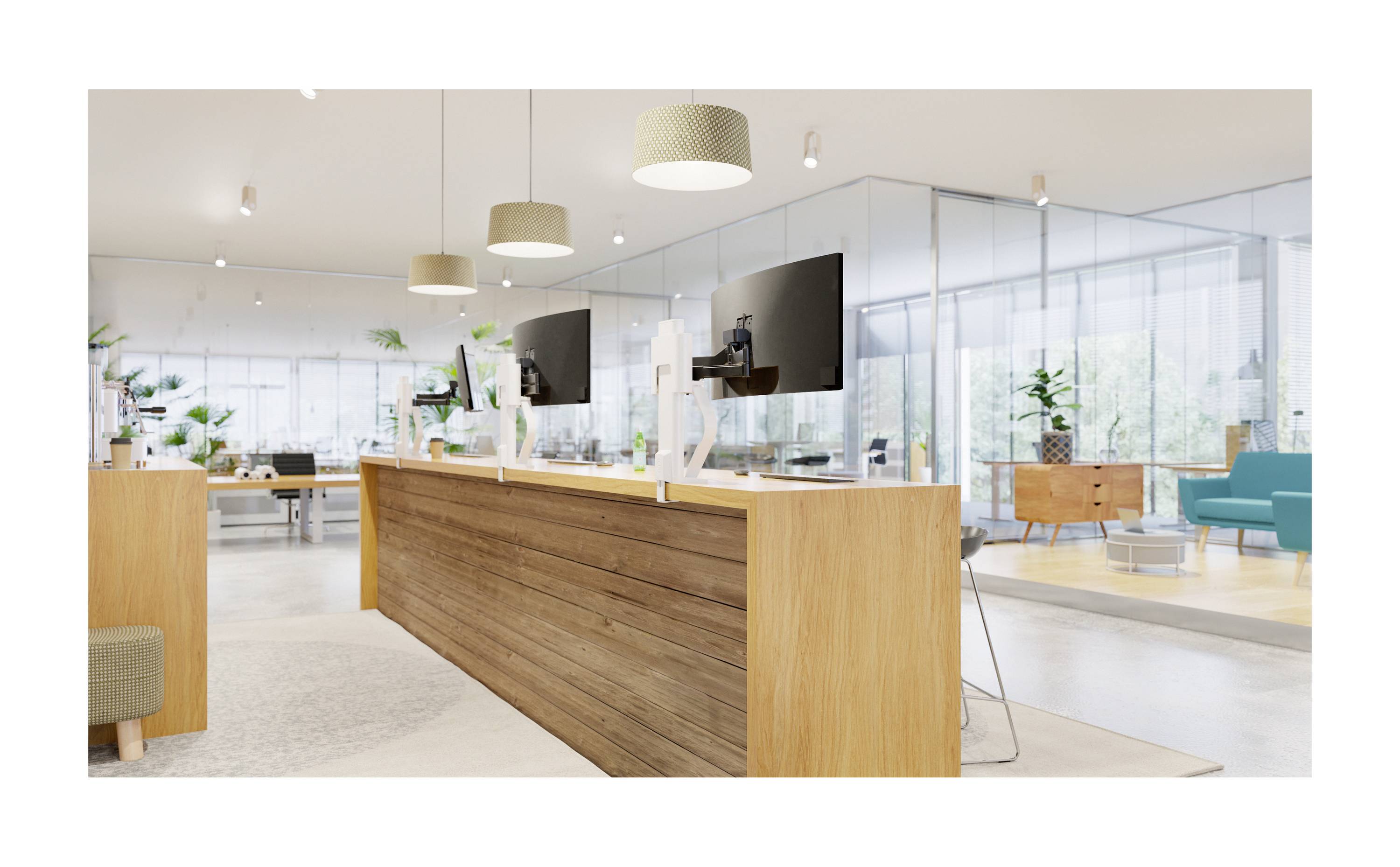 Modern, bright office with a wooden reception desk, computer monitors, and glass walls. Plants and furniture creating an inviting atmosphere.