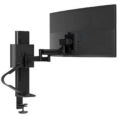 A black monitor mounting arm holds a large screen attached to a table. The arm is flexibly adjustable.
