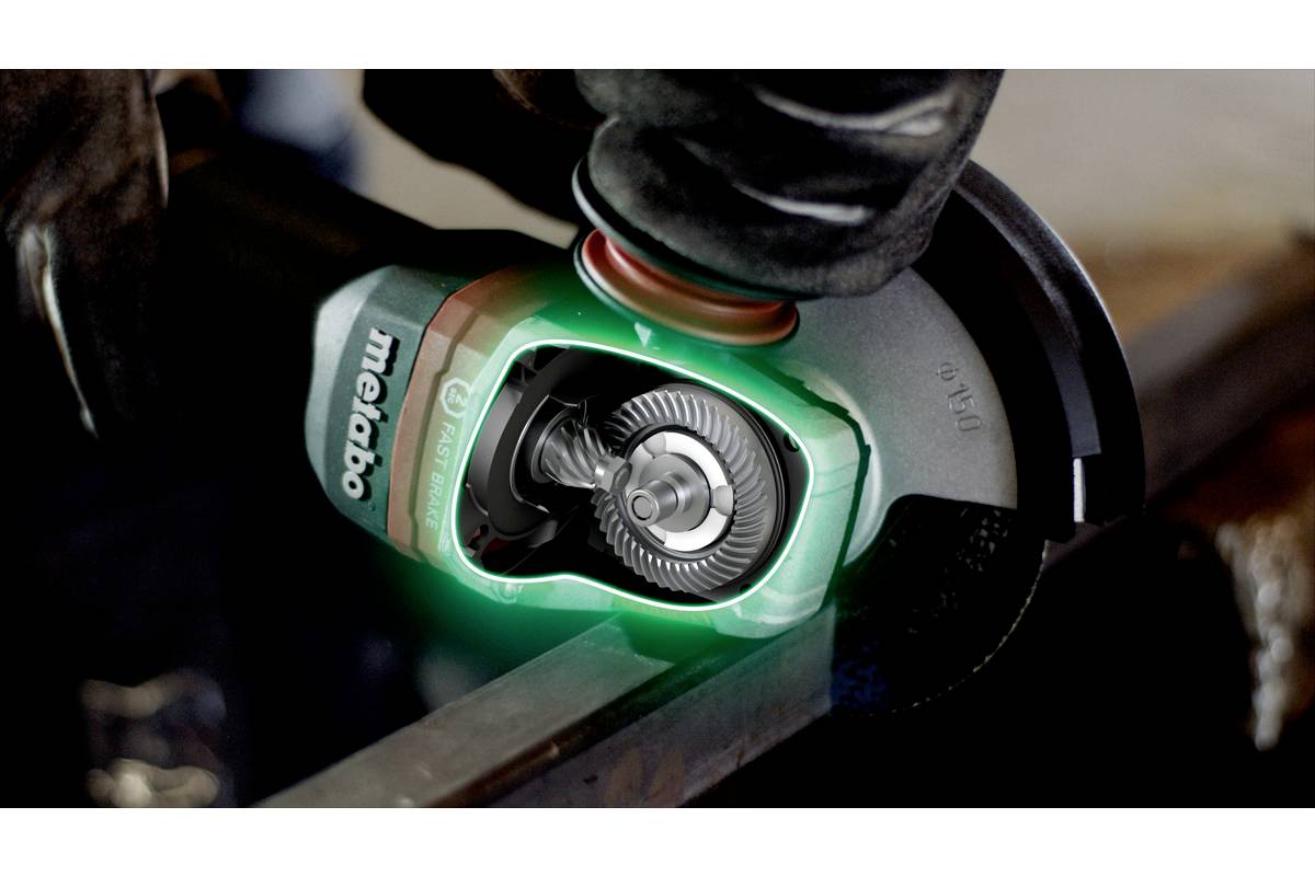 A person is holding an angle grinder working on a piece of metal. The grinder shows an illuminated gear through a transparent cover.