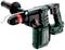 A green Metabo hammer drill with a black handle and red adjustment dial, suitable for heavy-duty drilling work.