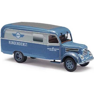 Blue and white vintage delivery van with the word 'CUSTOMER SERVICE' written on the side. The vehicle has markings and a nostalgic design.