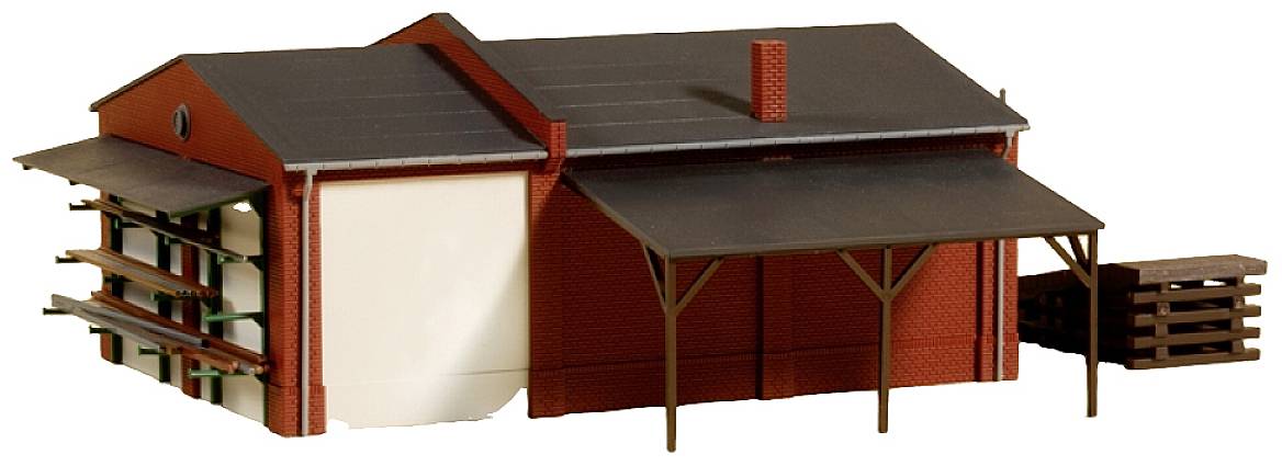 A model of a warehouse with red brick walls, a dark roof, and side canopy. Shelves are visible on the open side.