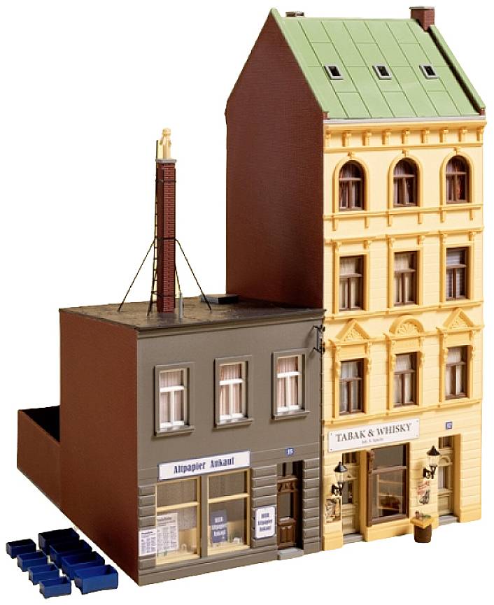 A model of two multi-storey buildings: on the left, a grey building with an 'Old Paper Purchased' sign, on the right, a yellow building with a 'Tobacco & Whisky' sign.