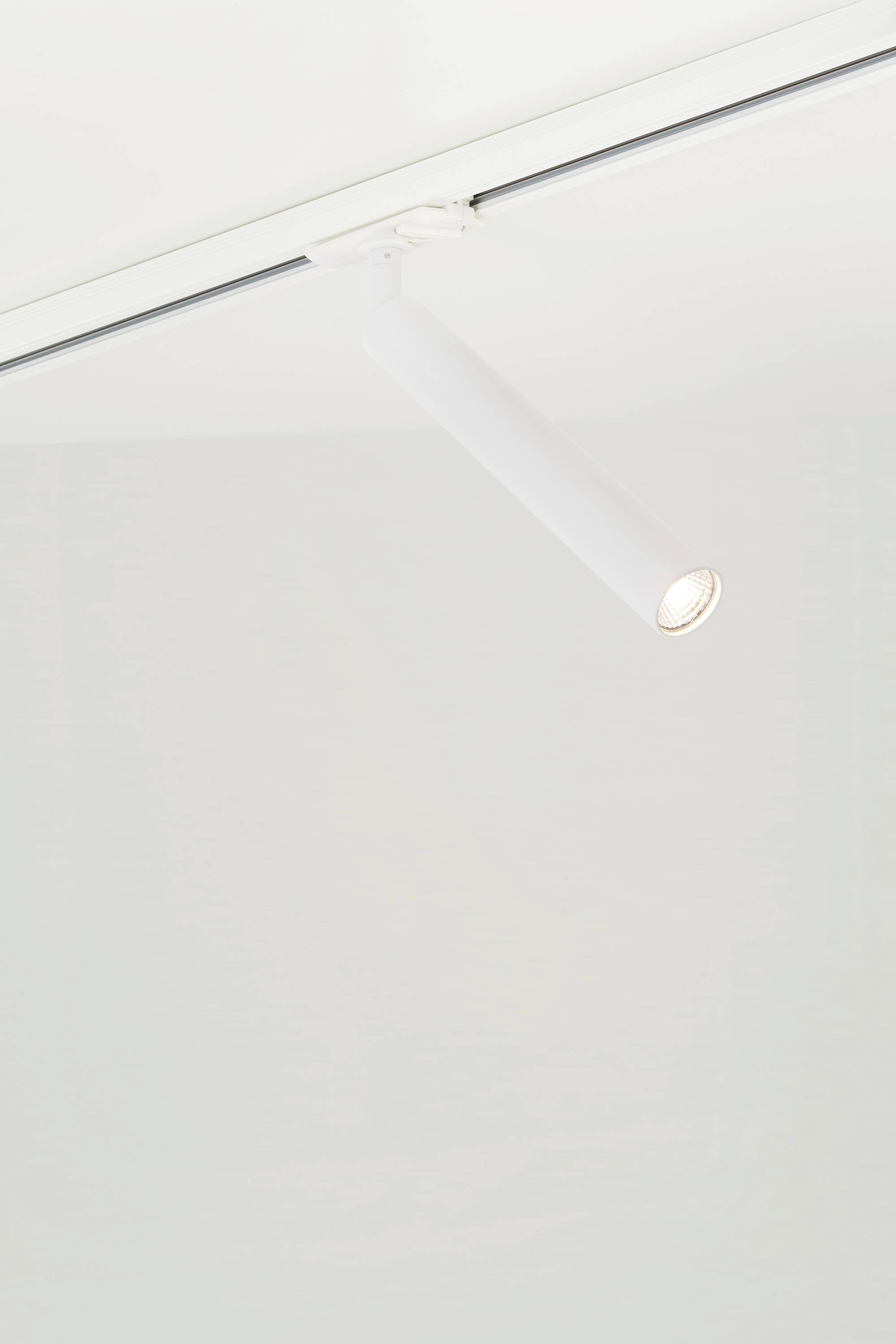 White ceiling spotlight in a modern style, which illuminates downwards.