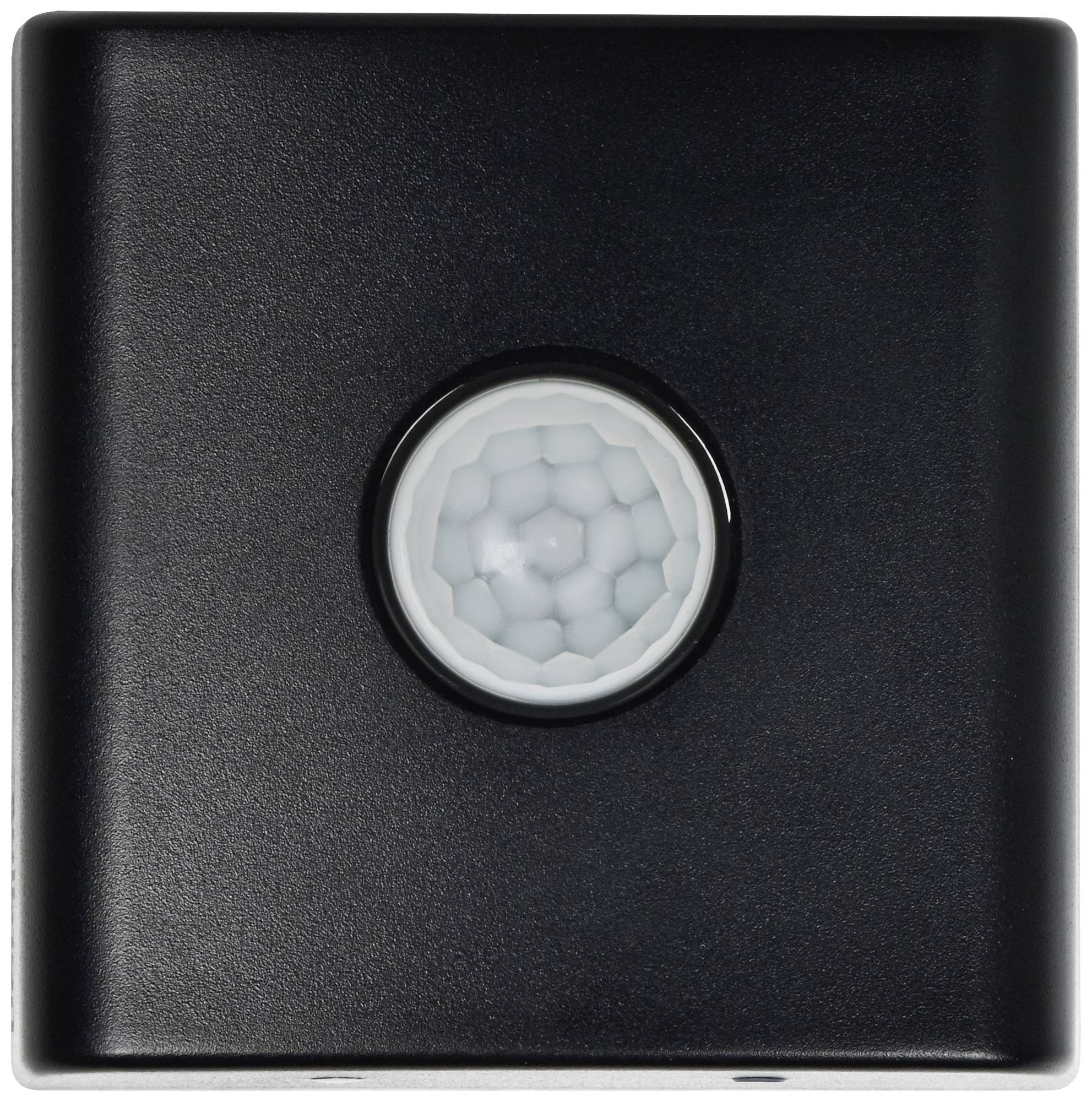 A black motion sensor, with a white sensor centrally located featuring a honeycomb-like pattern, for automatic light control.