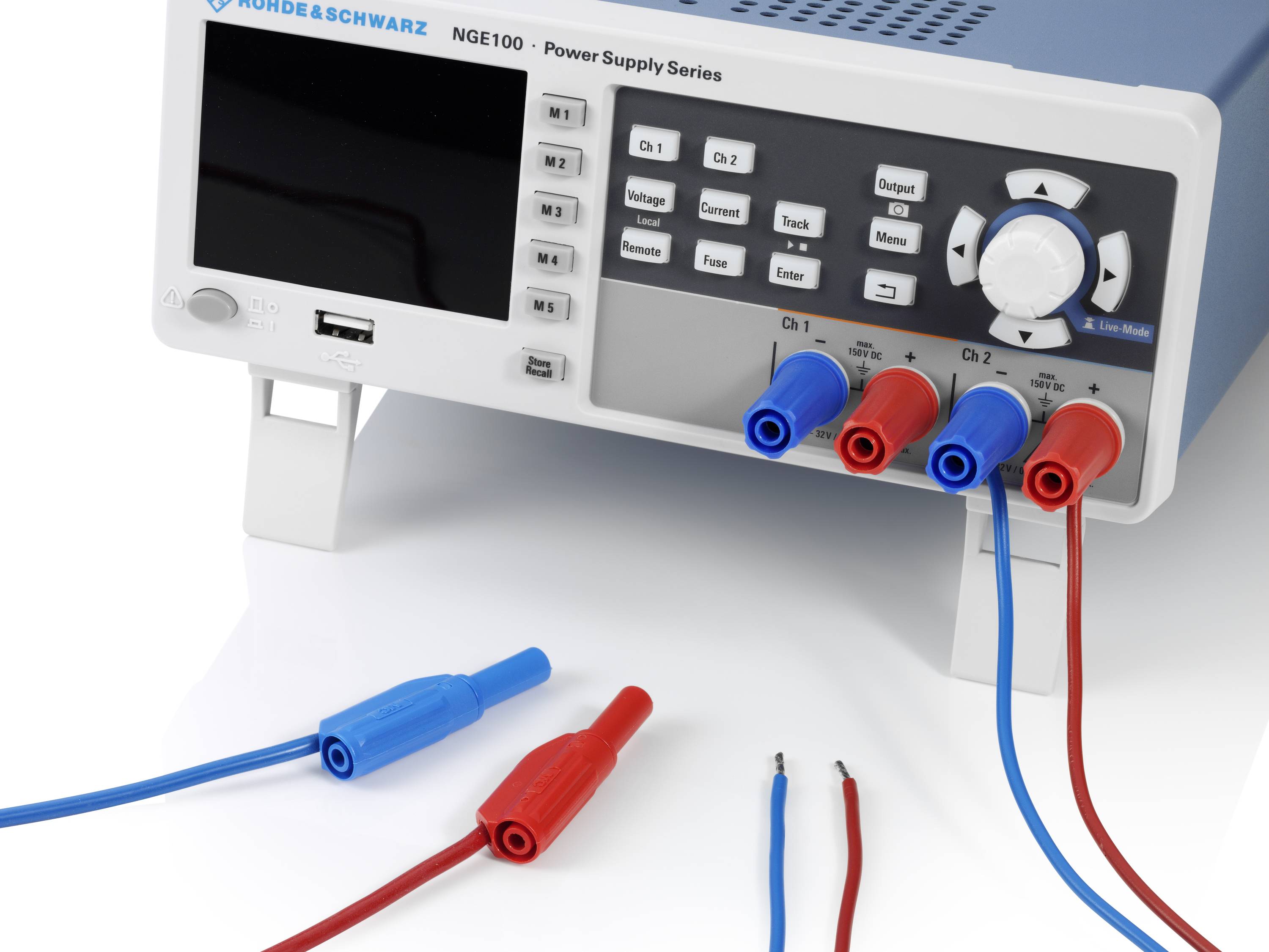 A power supply unit with multiple colourful connection terminals. Two measuring leads with red and blue banana plugs are connected at the front.