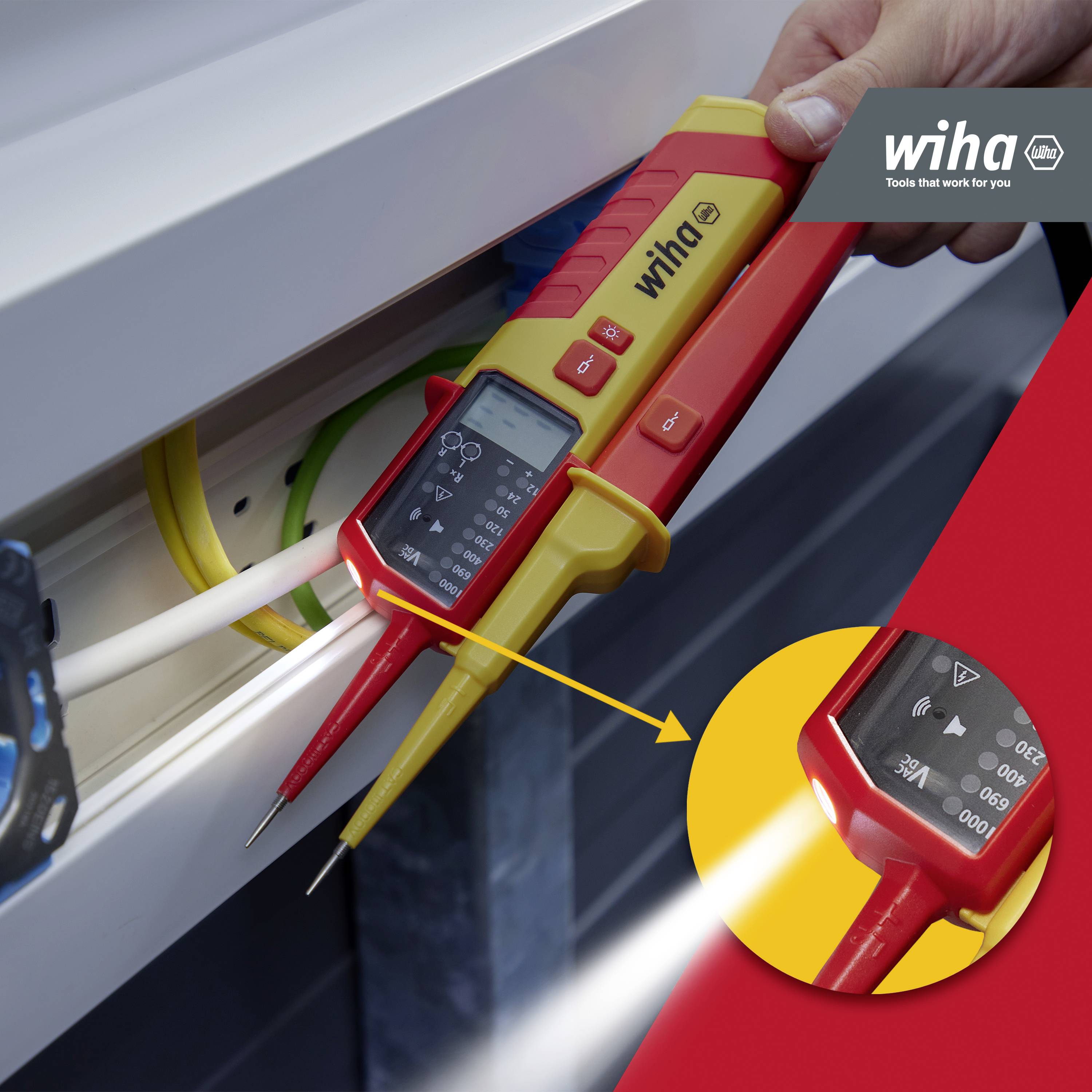 A two-pole voltage tester is used to test electrical cables. A magnifying glass enlarges the digital display.