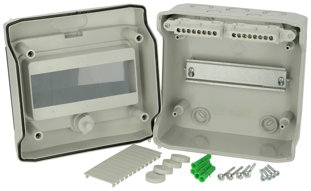 Housing for electrical installations with an open lid, showing internal structure and accessories such as screws and wall plugs.