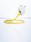 A yellow network cable is connected to a white network module resting on a glossy surface.