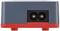 Close-up electronic device with a red stand and a black connection on the front.