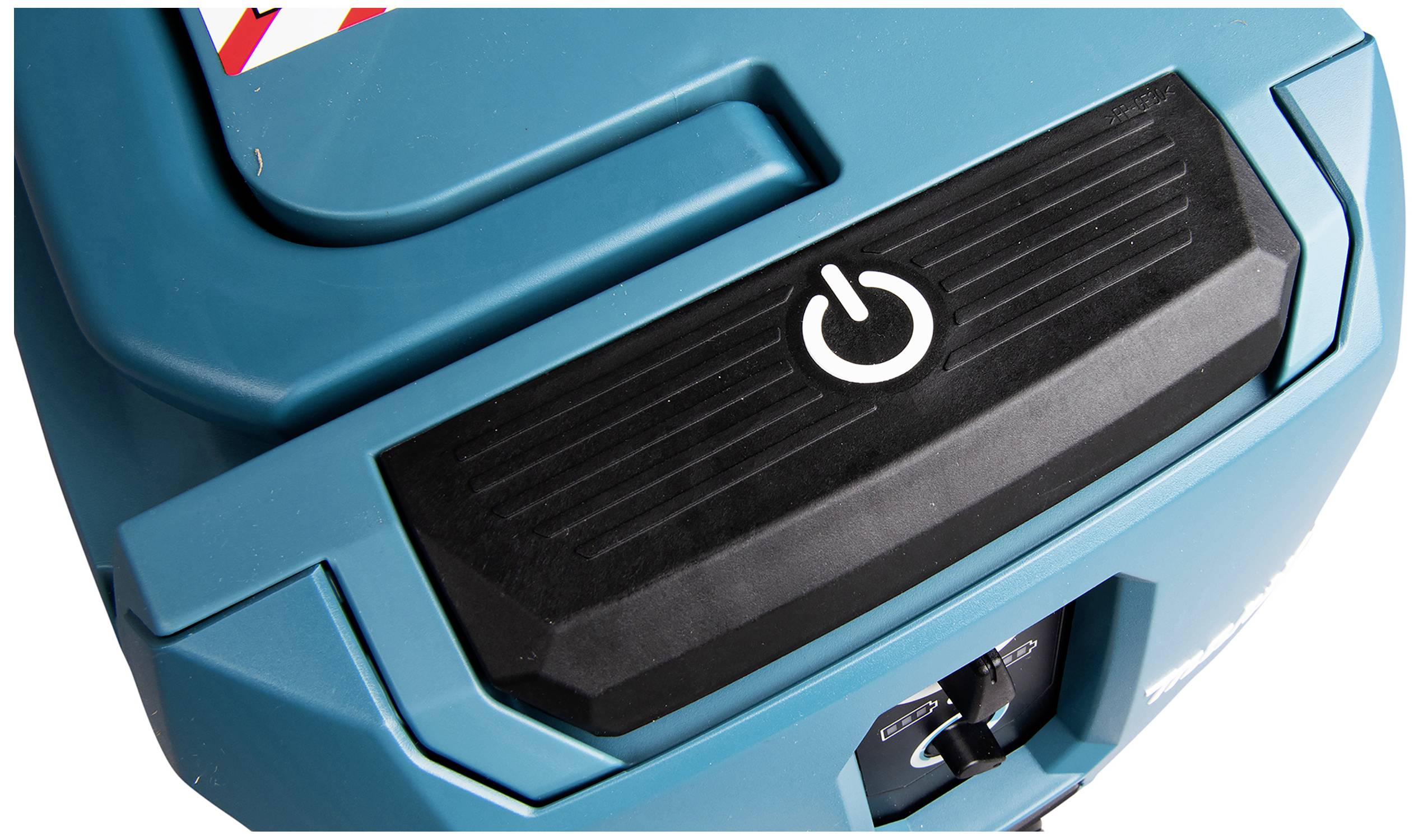 Blue, portable vacuum cleaner lid with a large, white on/off button in the centre and a black surface beneath it.