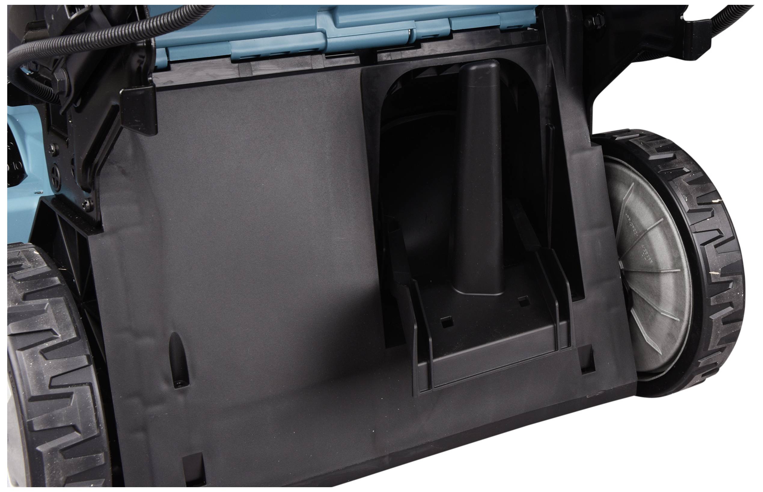 Close-up of a black plastic housing with large wheels on a machine or device.