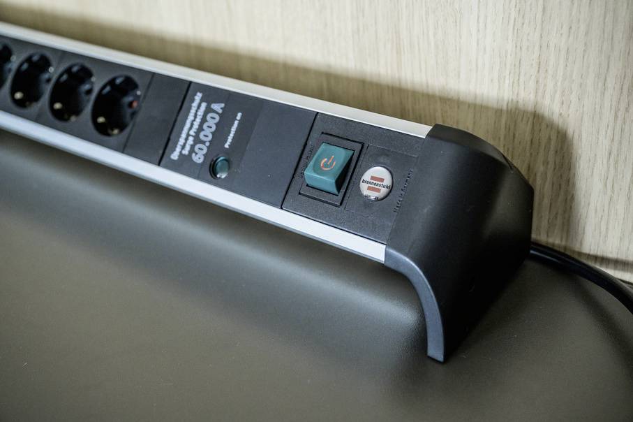 'Surge-protected power strip with rocker switch and red indicator light'