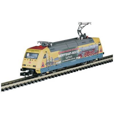 Model locomotive of Deutsche Bahn on a railway track, beige-yellow with printed 'Steam Railway Route Saxony' logo and illustrations.