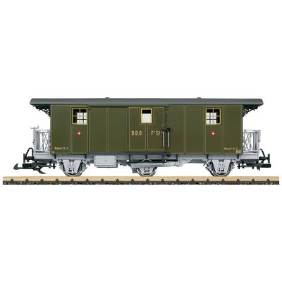 A view of a historic railway carriage with green paintwork and white windows, side-lettered with 'B.O.B. F51' and heraldic symbols.