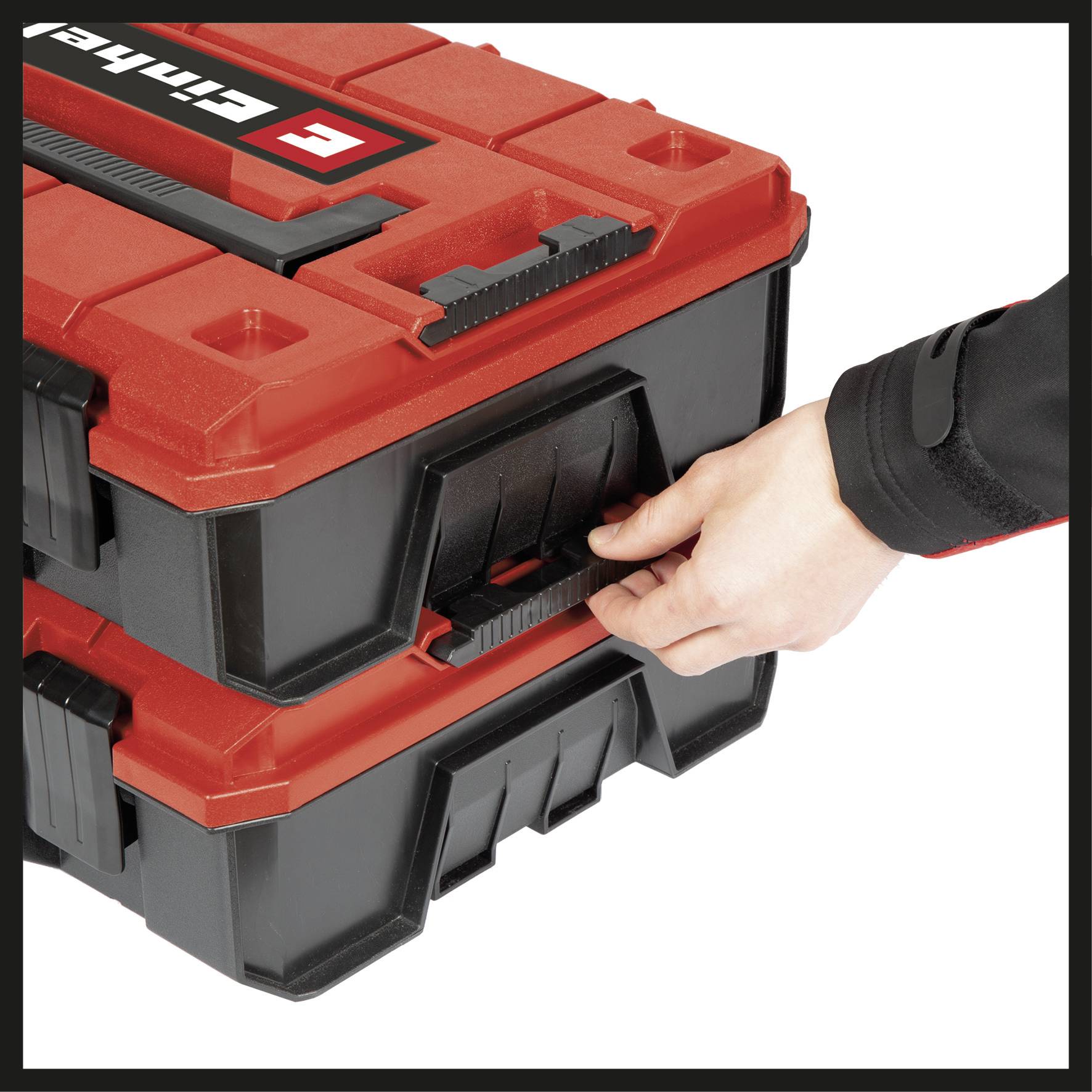 A person pulls a black handle on a red toolbox with the 'Einhell' logo.