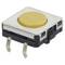 A yellow button with two metal terminals, suitable for electronic circuits. Rectangular design with rounded corners.