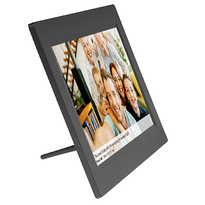 Digital photo frame displays a picture of a smiling group, including several adults and children in a living room.